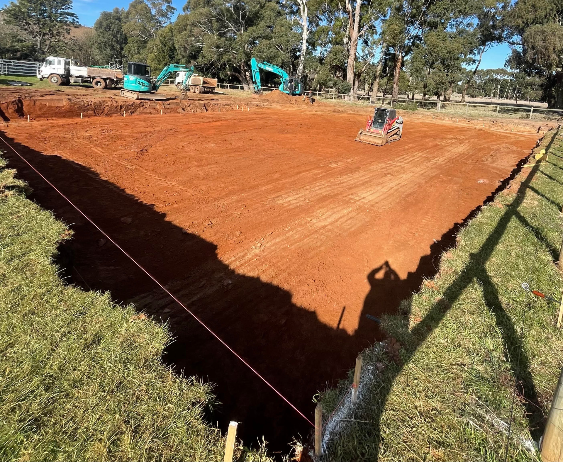 Rural bulk dig and pad prep — Large rural building pad bulk excavated, trimmed and compacted with multiple machines on site
