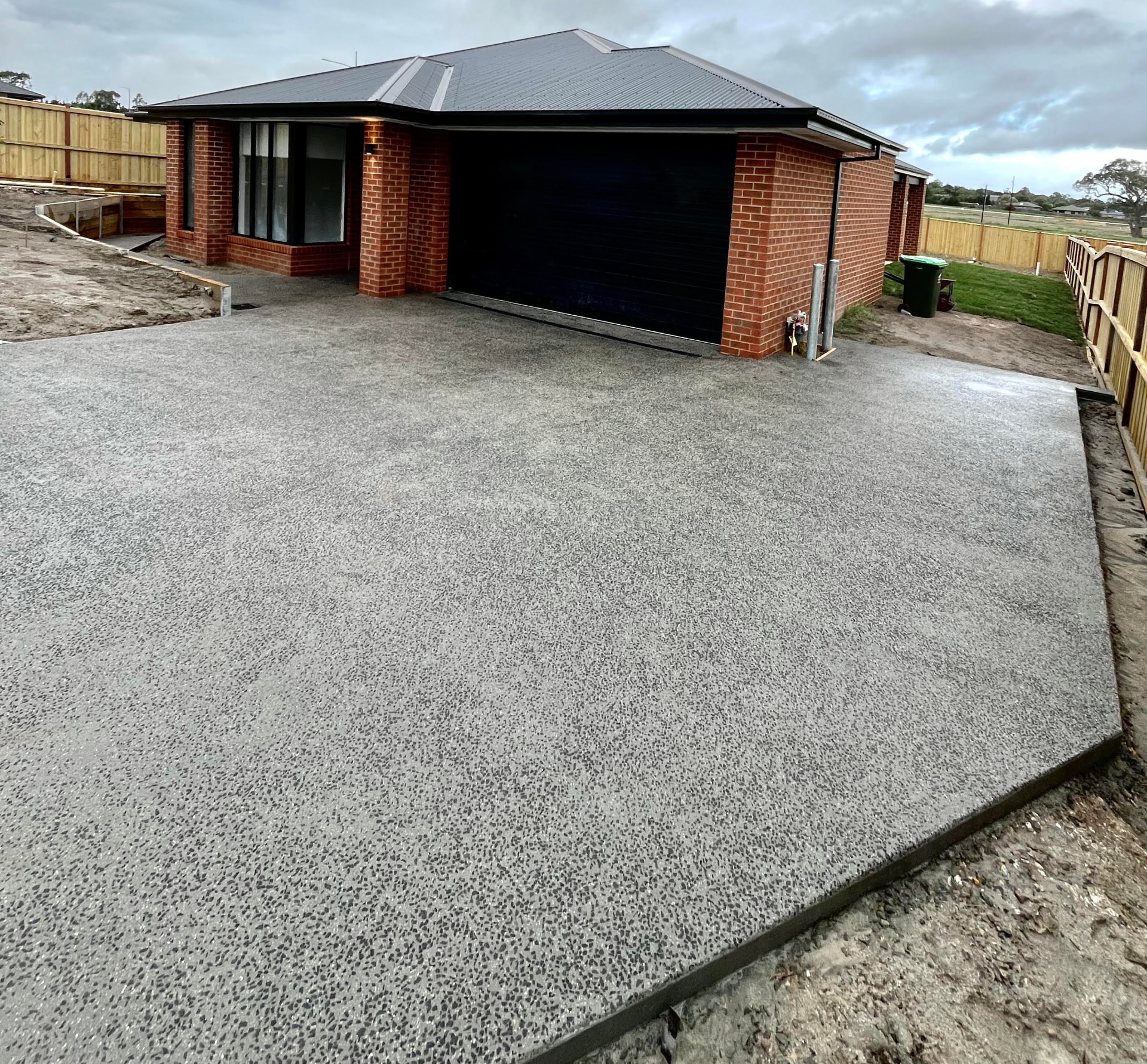 New build exposed aggregate driveway — Driveway and crossover poured and washed to a new home, completed in a single day