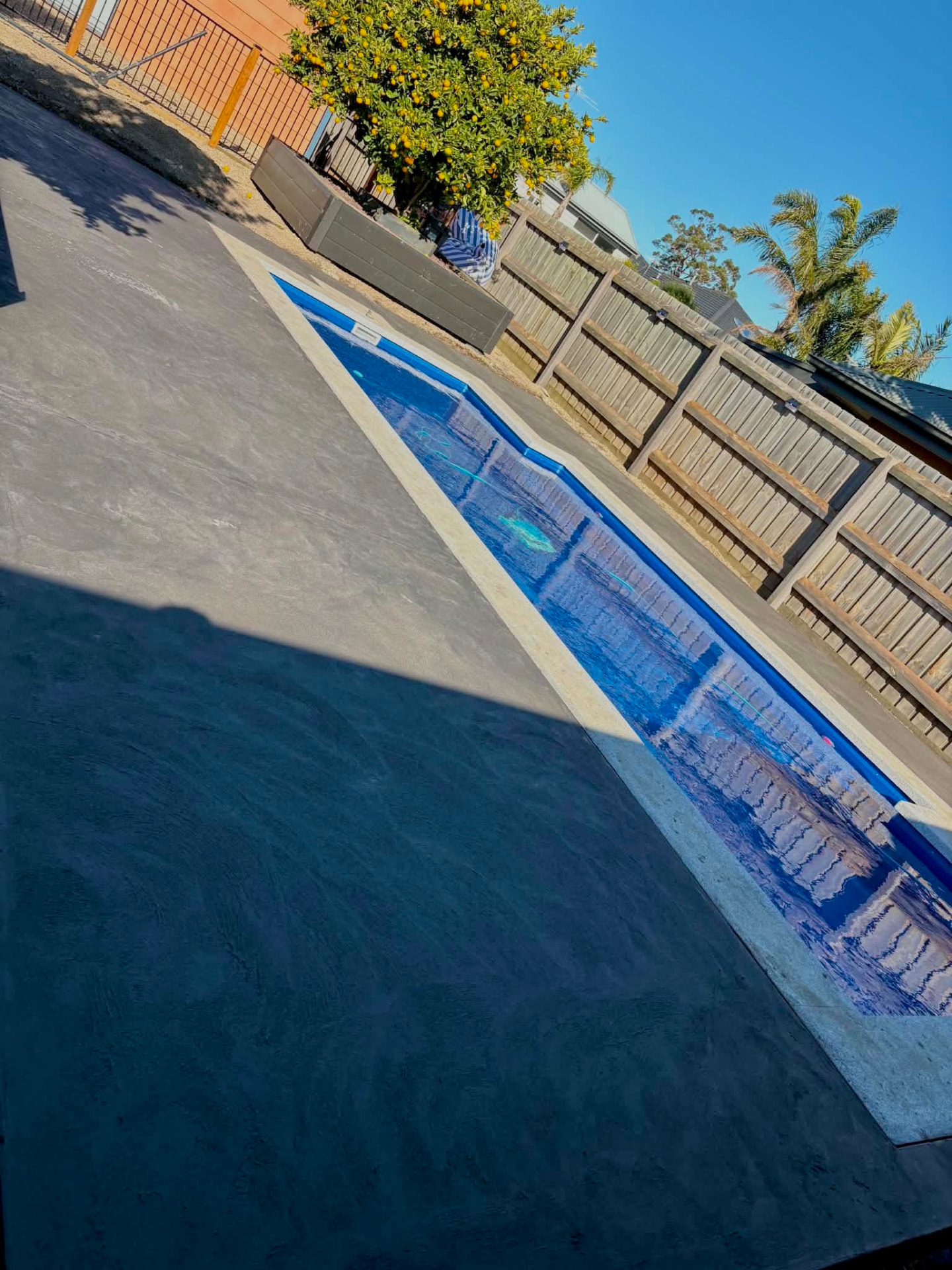 Charcoal exposed aggregate pool surround and deck