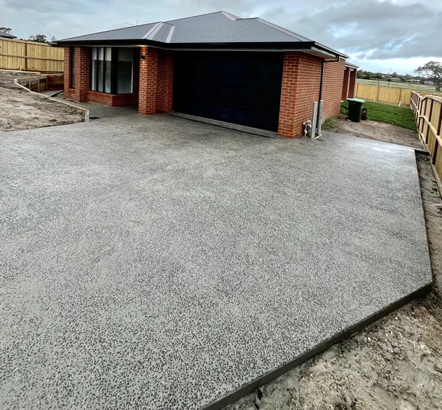 New build exposed aggregate driveway — Driveway and crossover poured and washed to a new home, with coordinated drainage and concrete works